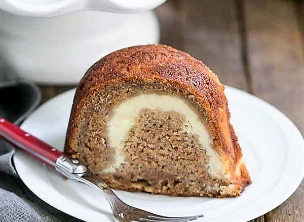 Apple Bundt Cake on a white dessert plate with a red handled fork