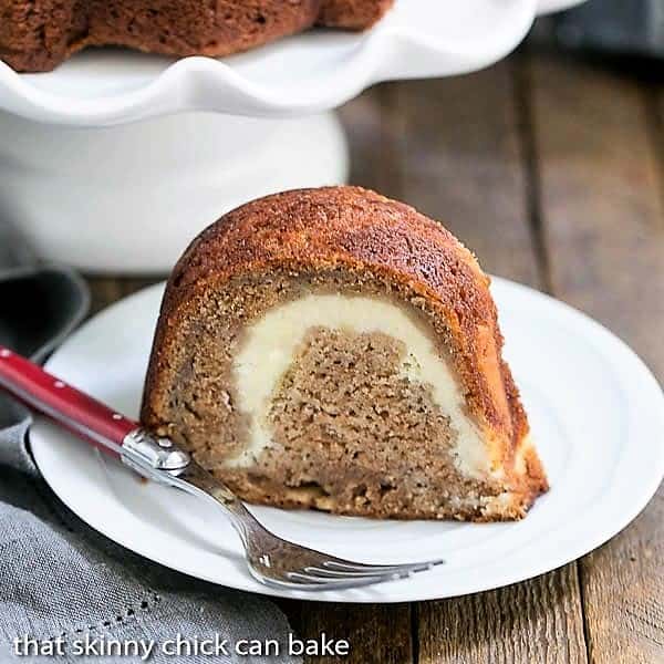 Apple Bundt Cake on a white dessert plate with a red handled fork.