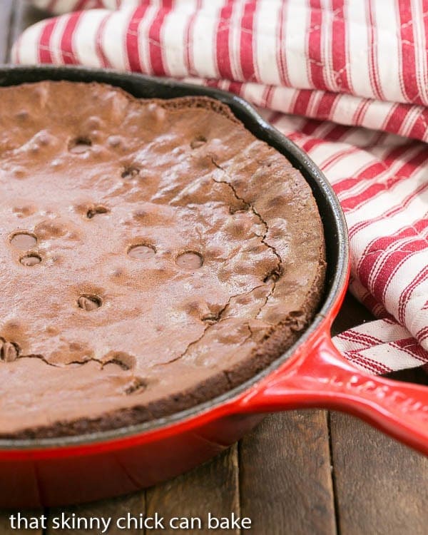 Fudgy Skillet Browniesin a red skillet with 2 hot pads.