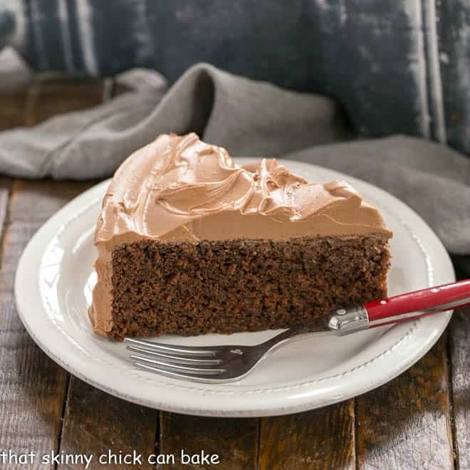 One Layer Mocha Cake on a white plate with a red handled fork