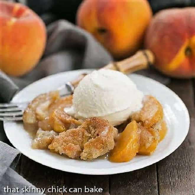 Peach pudding on a white plate with a scoop of vanilla ice cream