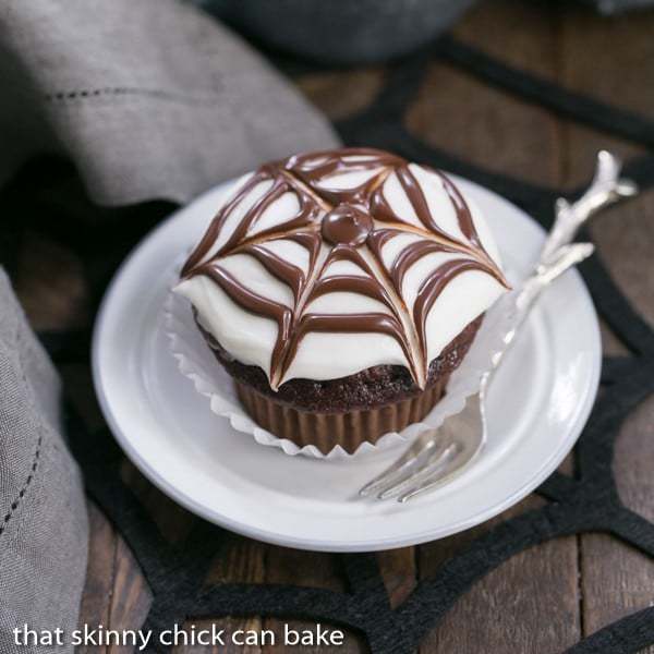 Spiderweb Cupcake on a white dessert plate with a silver fork