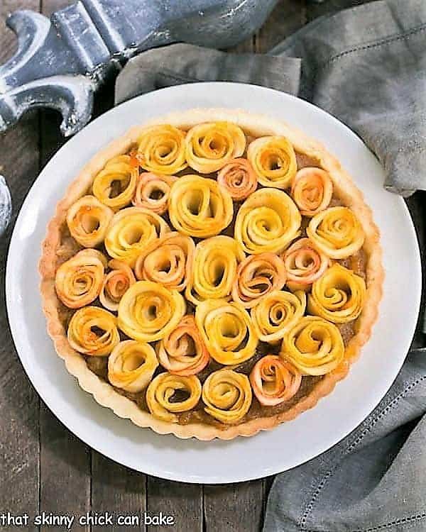 Overhead view of Rose Apple Tart on a white ceramic plate.