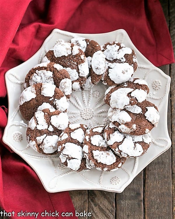 A ring of Chocolate Crackle Cookies on a white serving plate.