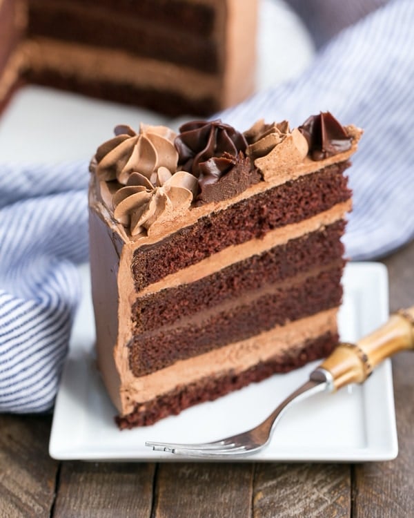 Chocolate Fudge Layer Cake slice on a square white plate.