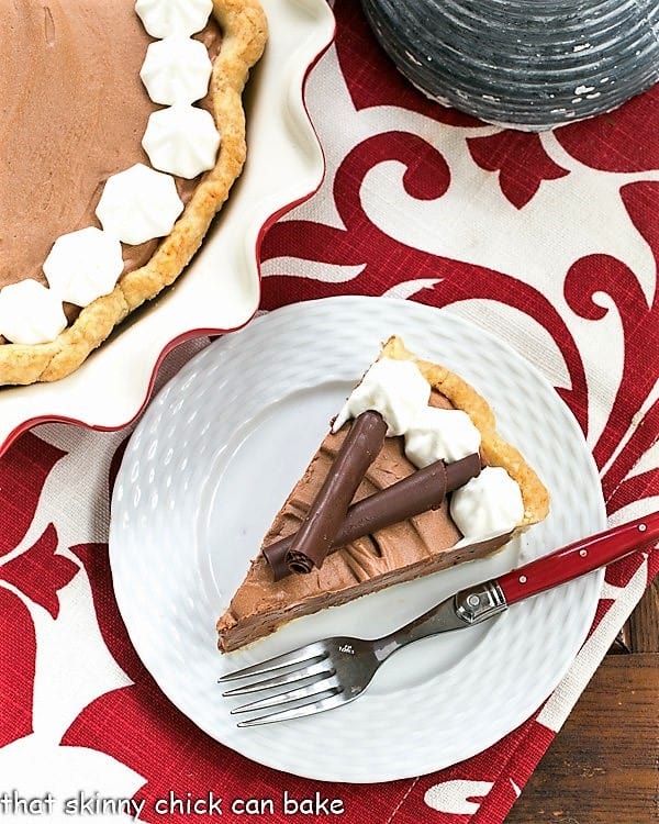 French Silk Pie slice garnished with chocolate curls and whipped cream