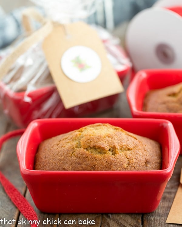 Mini Pumpkin Breads in a small red ceramic loaf pan.