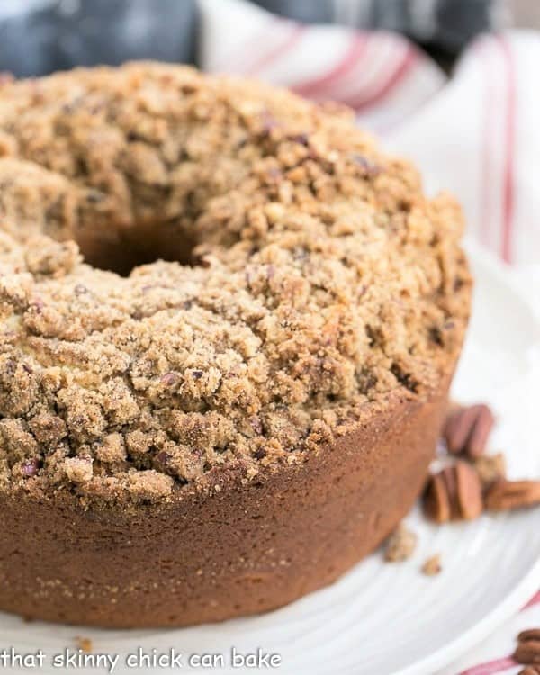 Streusel Coffeecake Pound Cake on a white plate with a view of the top covered with crumbs.