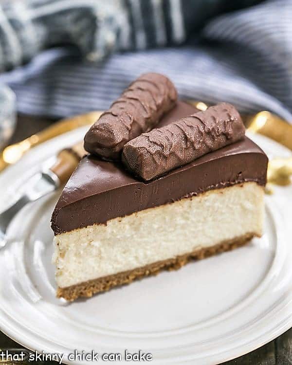 Twix Cheesecake slice on a white dessert plate