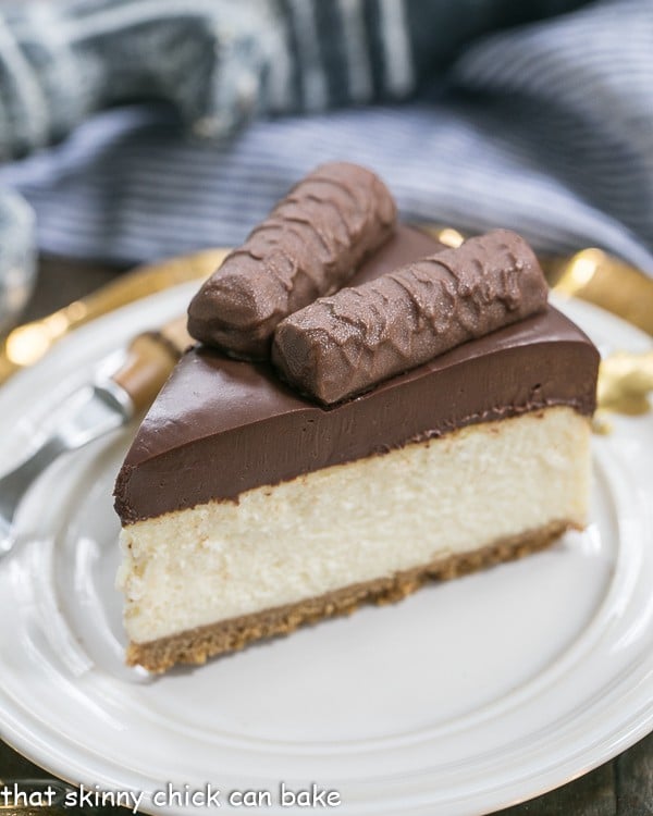 A slice of Twix Cheesecake on a white plate