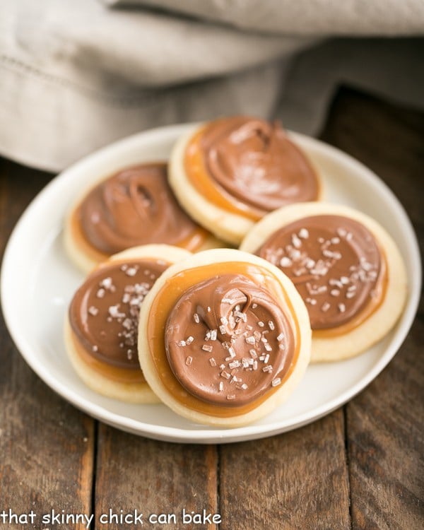 Chocolate Caramel Shortbread Cookies on a round white plate.