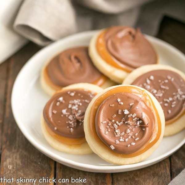 Chocolate Caramel Shortbread Cookies arranged on a white ceramic plate.