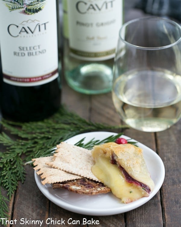 Cranberry Brie en Croute slice on a small appetizer plate with crackers.