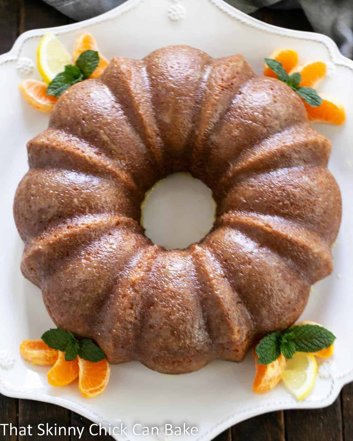 Overhead view of easy lemon bundt cake on a white cake plate.