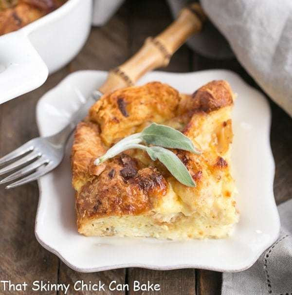 A slice of  sausage croissant french toast on a white plate with a fork