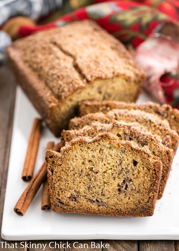 half a loaf of Cinnamon Topped Banana Bread next to slices of the banana bread