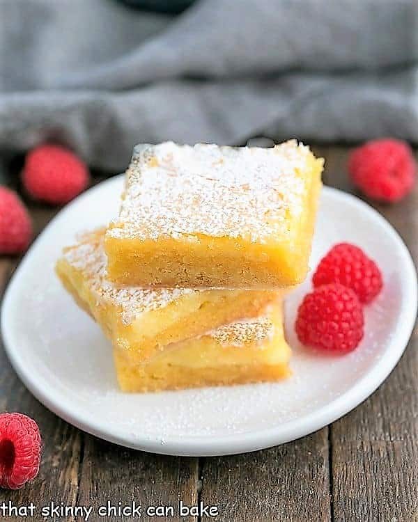Stack of Gooey Butter Bars on a dessert plate.