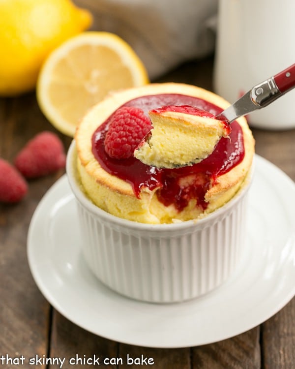 Raspberry Topped Lemon Soufflés with a spoonful removed