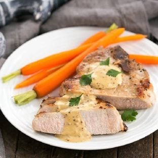 Pork Chops Dijonnaise on a white plate with carrots