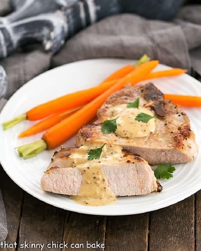 Pork Chops Dijonnaise on a white plate with carrots.