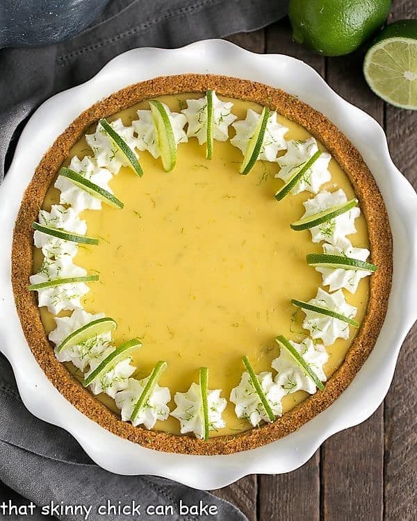 Key Lime Pie with Graham Cracker Crust in a white ceramic pie plate.