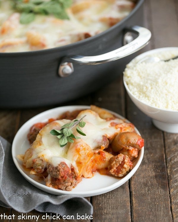 white dinner plate of Cavatini Supreme with the casserole pan full of it behind the plate