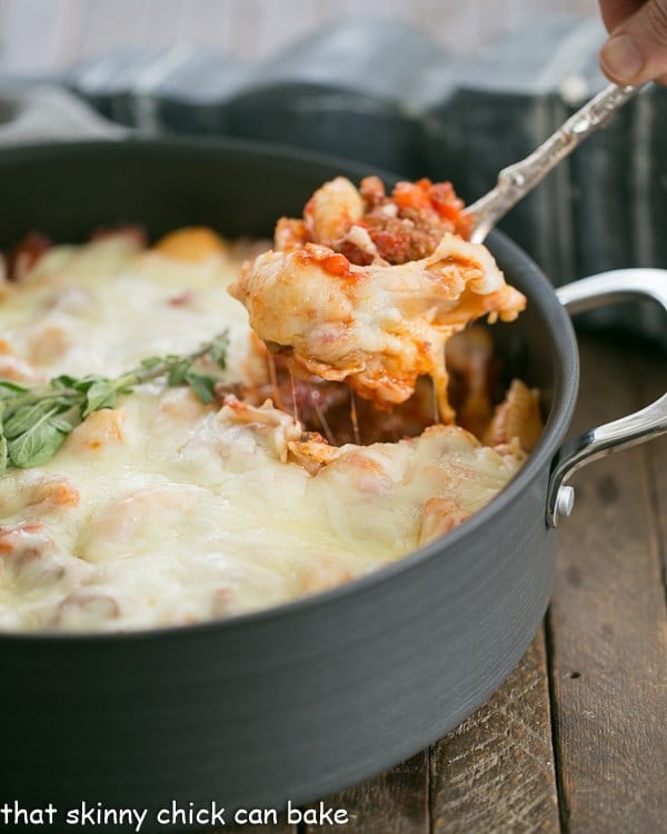 Cavatini Supreme baked into a large pan, with a spoonful being served from it