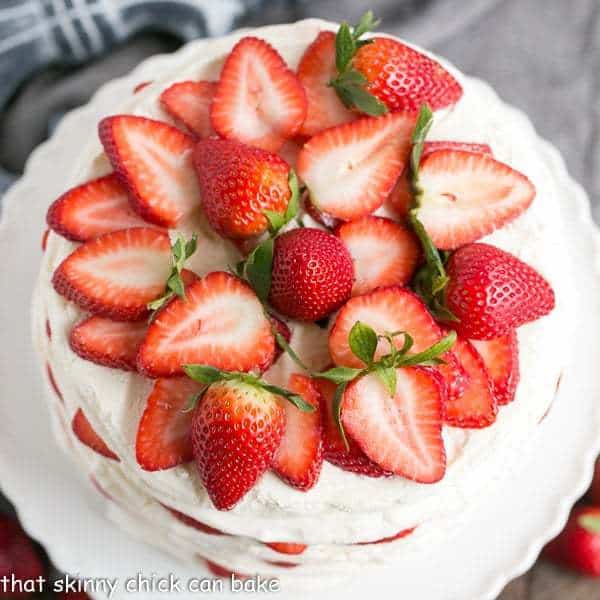 Fresh Strawberry Meringue Cake from above on a white cake stand.