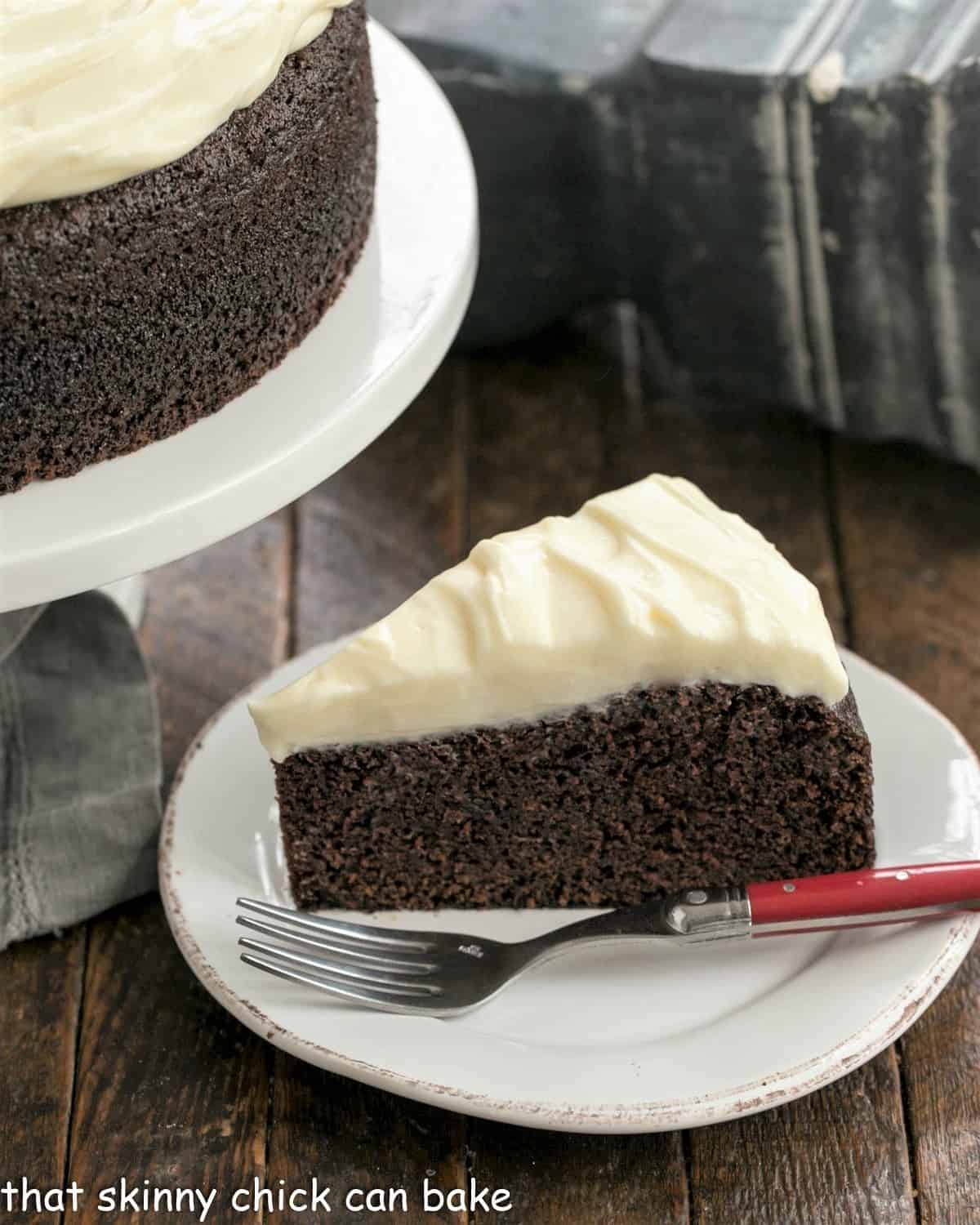 Chocolate Guinness Cake is a rich chocolate cake spiked with Guinness ale and topped with cream cheese icing. This easy chocolate cake recipe is makes the perfect St. Patrick's Day dessert! #stpatricksday #dessertrecipe #chocolate #cake #recipe overhead image of a cream cheese frosted Guinness infused chocolate cake.