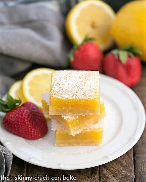 he Best Lemon Bars stacked on a white dessert plate.