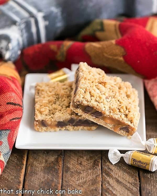 2 Oatmeal Caramel Bars stacked on a square dessert plate