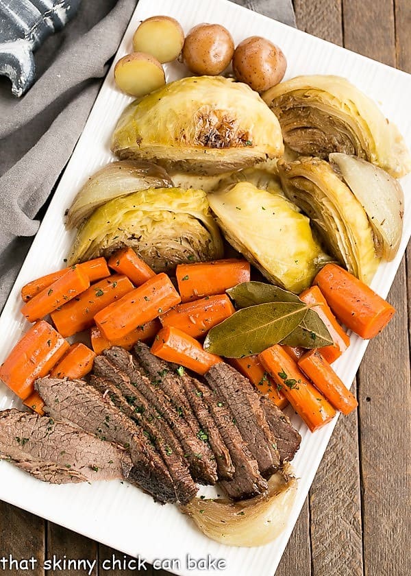 overhead photo of a platter of Irish Braised Corned Beef, carrots, cabbage, and potatoes