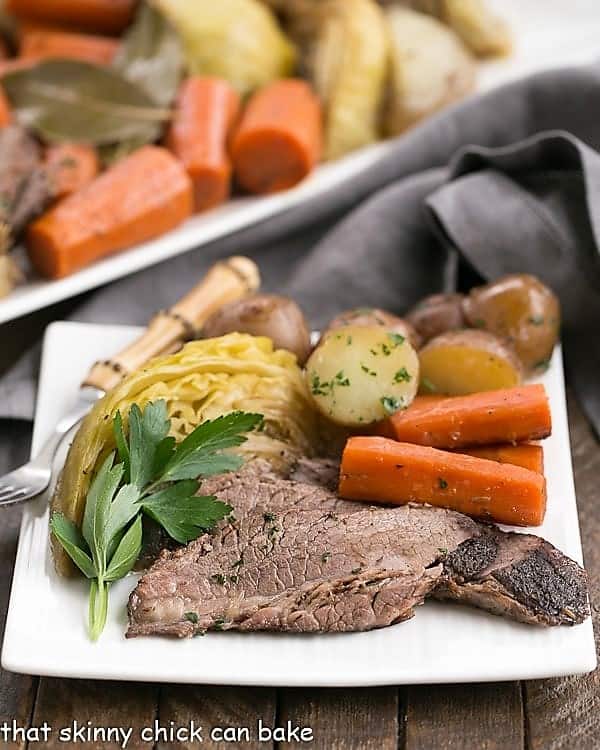 Irish Braised Corned Beef and cabbage dinner on a white plate.