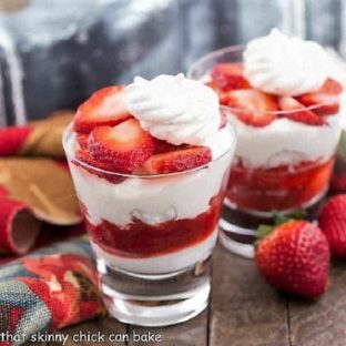 2 servings of strawberry Eton Mess with homemade strawberry sauce in two clear glasses