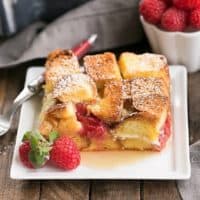 Raspberry Mascarpone French Toast Casserole slice on a square white plate