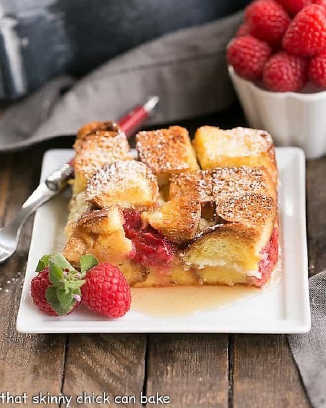 Raspberry Mascarpone French Toast Casserole slice on a square white plate.