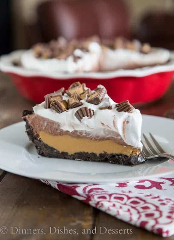 Slice of peanut butter cup pie in front of a red pie plate