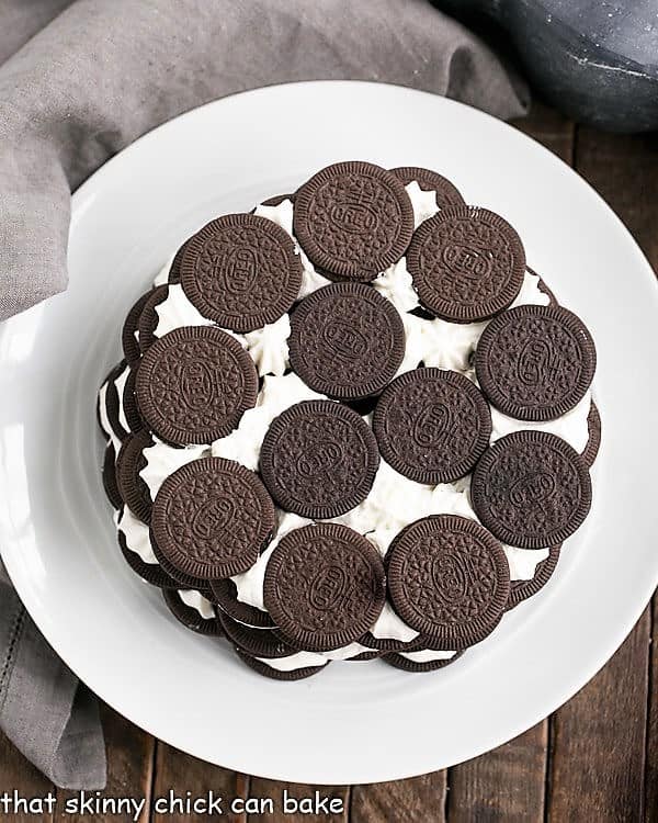 Overhead view of Oreo Icebox Cake on a white plate with a gray napkin