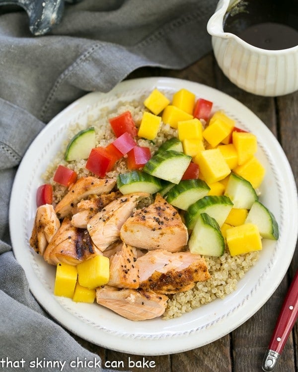 Caribbean Salmon Quinoa Salad on a white salad plate with a red fork