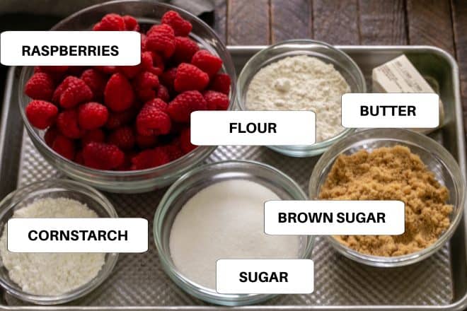 Labeled ingredients for raspberry crisp on a metal sheetpan.