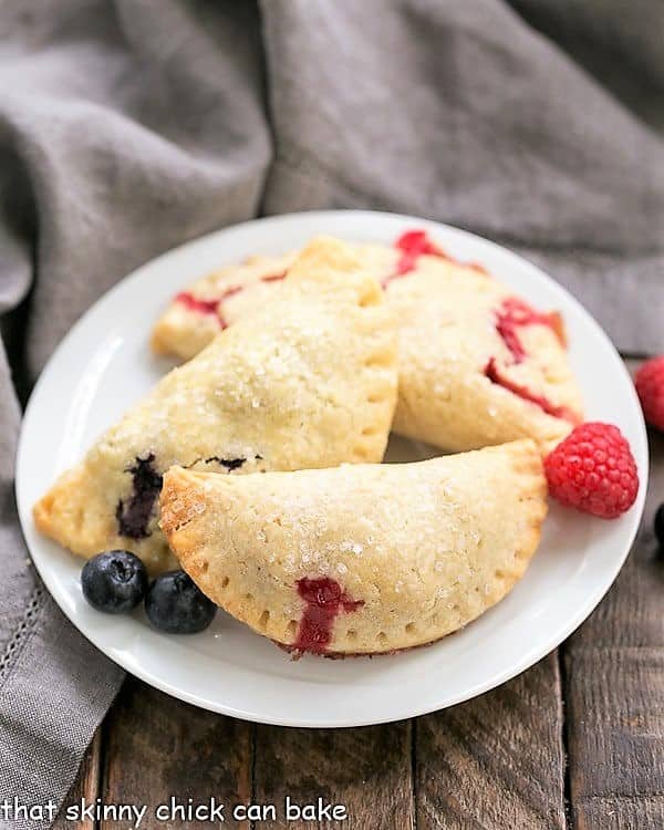 Rustic Berry Turnovers on a round white plate.