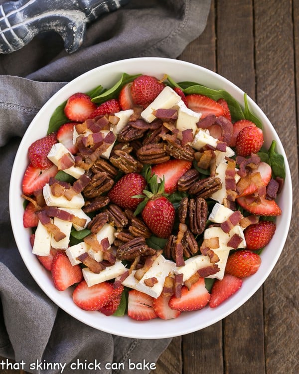 Strawberry Bacon Brie Salad in a round white serving bowl from overhead.