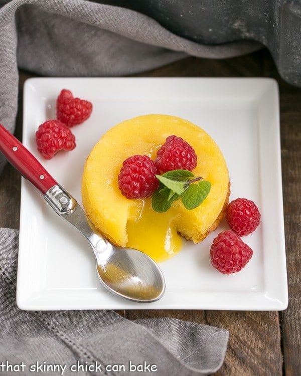White Chocolate Molten Lava Cakes - Dreamy individual white chocolate cakes with molten centers! White Chocolate Molten Lava Cakes on a square, white ceramic plate