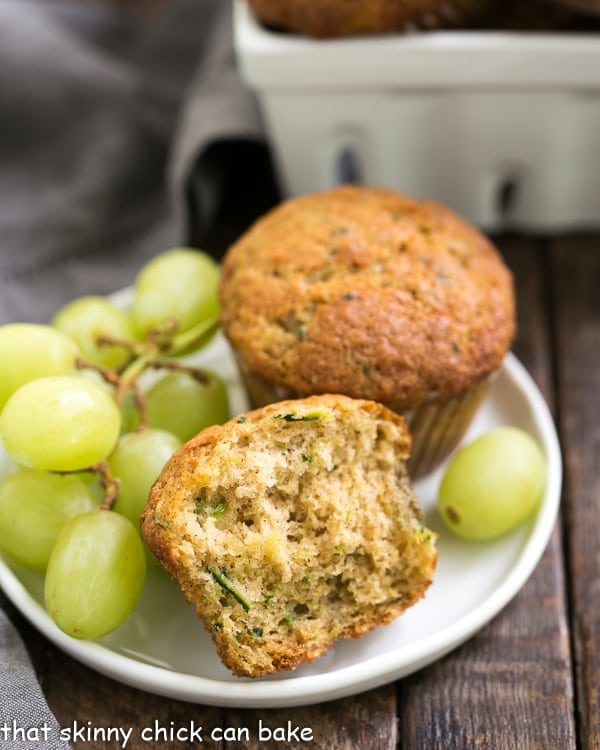 Cinnamon Zucchini Muffins on a small white plate with green grapes