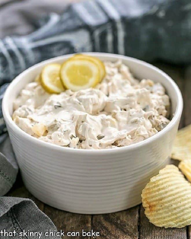 Easy Dill Pickle Dip in a white bowl garnished with pickle slices