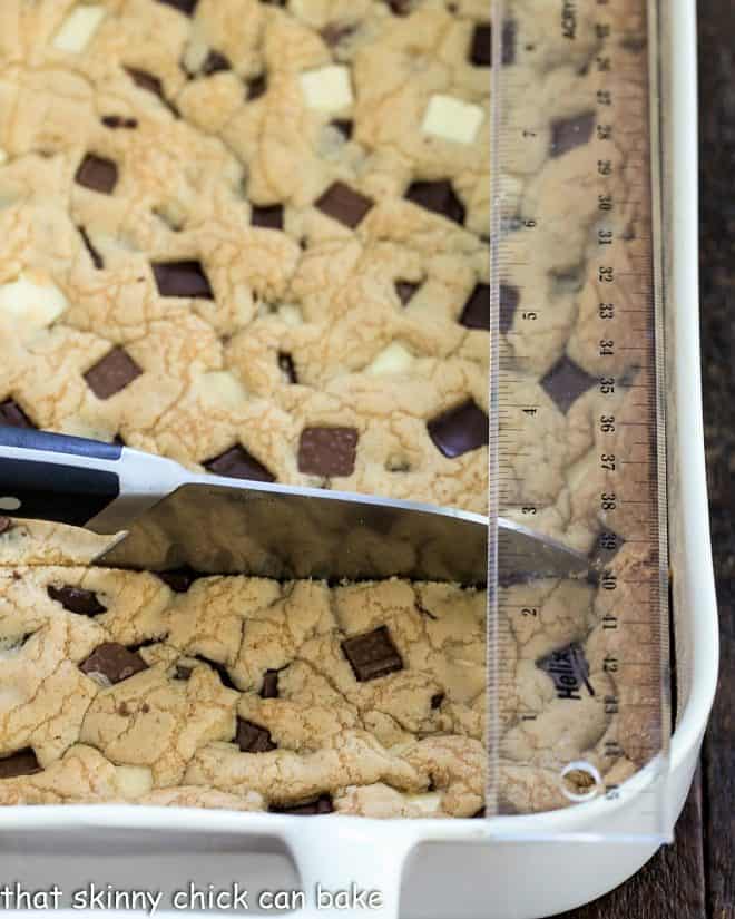 Bar cookies with a knife and ruler that are ready for precision cutting