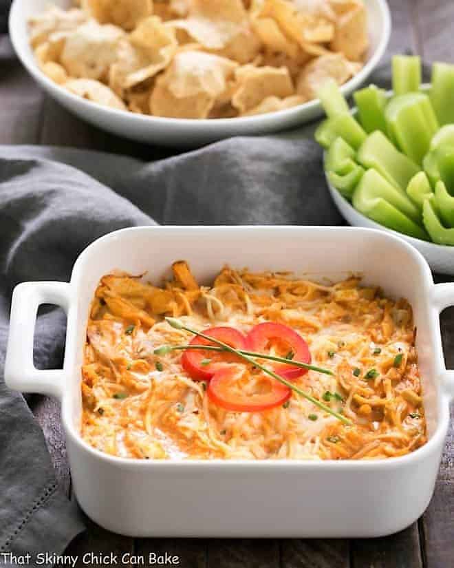 Buffalo Chicken Dip Recipe in a baking dish garnished with a pepper slice and chives.