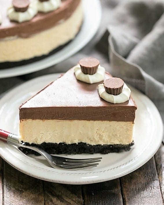 A slice of Chocolate Peanut Butter Pie on a white dessert plate with a red handled fork.