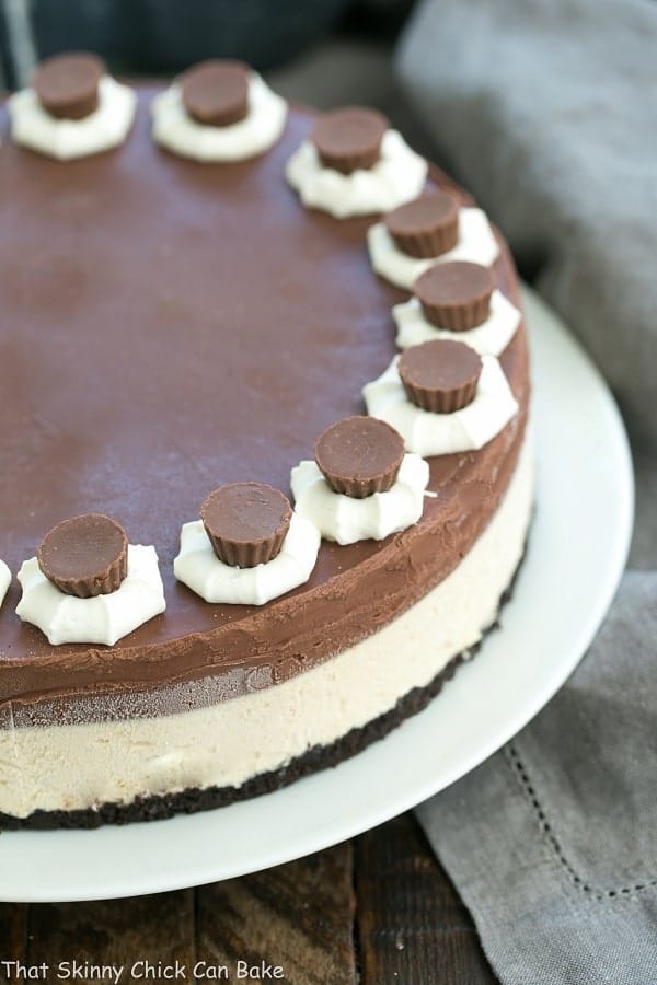 Chocolate Peanut Butter Pie topped with small whipped cream roses and mini Reeses peanut butter cups.