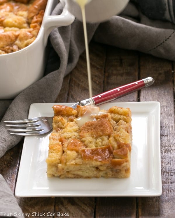 Whiskey sauce pouring over Cinnamon Bread Pudding.